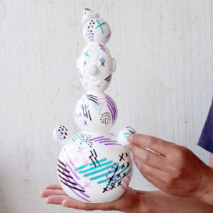 holding a piece of ceramic